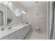 Bright bathroom with double vanity, tile floors, and charming round window for natural light at 4306 Windy Heights Dr., North Myrtle Beach, SC 29582
