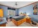 Vibrant bedroom with light blue walls, a wooden bed with built-in storage, and a ceiling fan at 4306 Windy Heights Dr., North Myrtle Beach, SC 29582