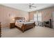 Spacious bedroom with a large bed, coordinated decor, and a ceiling fan for added comfort at 4306 Windy Heights Dr., North Myrtle Beach, SC 29582
