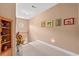 A bright hallway featuring neutral paint, carpet, and artwork creating an inviting transition space at 4306 Windy Heights Dr., North Myrtle Beach, SC 29582