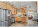 Well-organized kitchen with stainless steel appliances, wooden cabinetry, and tiled backsplash at 4306 Windy Heights Dr., North Myrtle Beach, SC 29582