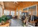 Cozy sunroom filled with light featuring tile flooring and wood paneling at 4306 Windy Heights Dr., North Myrtle Beach, SC 29582
