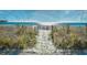 Sandy beach with a fence, vegetation, and a bright blue ocean at 4717 Cobblestone Ln. # B3, Myrtle Beach, SC 29577