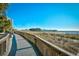 Elevated boardwalk along the beach with views of the ocean, fishing pier, and vegetation at 4717 Cobblestone Ln. # B3, Myrtle Beach, SC 29577