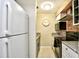 This kitchen features a white refrigerator and white cabinetry, stainless steel appliances, and granite countertops at 4717 Cobblestone Ln. # B3, Myrtle Beach, SC 29577