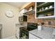 This well-lit kitchen features stainless steel appliances, granite countertops, and an eye-catching brick backsplash at 4717 Cobblestone Ln. # B3, Myrtle Beach, SC 29577