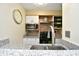 Well-lit kitchen featuring stainless steel appliances, granite countertops, and eye-catching brick backsplash at 4717 Cobblestone Ln. # B3, Myrtle Beach, SC 29577