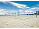 Beach volleyball court with nets and American flags under a bright blue sky with some buildings nearby at 4717 Cobblestone Ln. # B3, Myrtle Beach, SC 29577