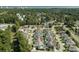Overhead view of a residential neighborhood, showcasing lush greenery, community pools, and nearby ocean views at 4856 Bermuda Way N, Myrtle Beach, SC 29577