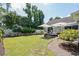 Well-maintained backyard with lush lawn, brick patio, outdoor seating and landscaped garden at 4856 Bermuda Way N, Myrtle Beach, SC 29577