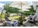 Relaxing backyard patio area, complete with patio furniture, hanging chairs and lush greenery at 4856 Bermuda Way N, Myrtle Beach, SC 29577