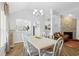 Dining room featuring modern chandelier, open to kitchen with table and white chairs at 4856 Bermuda Way N, Myrtle Beach, SC 29577