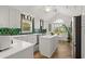 Stylish kitchen with white cabinetry, stainless steel appliances, island and vibrant green backsplash at 4856 Bermuda Way N, Myrtle Beach, SC 29577