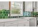 Close-up of kitchen details featuring stainless steel appliances, white countertops, and vibrant backsplash at 4856 Bermuda Way N, Myrtle Beach, SC 29577