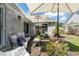 Cozy patio featuring cushioned seating, vibrant foliage, and a shaded retreat under large umbrellas, ideal for outdoor enjoyment at 4856 Bermuda Way N, Myrtle Beach, SC 29577