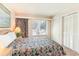 Bright bedroom featuring floral bedding, neutral walls, and double closets, creating a cozy, inviting retreat at 491 Ocean Creek Dr. # 2613, Myrtle Beach, SC 29572