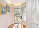 Bright entryway with wood flooring and a view of the outdoor balcony through the glass door at 491 Ocean Creek Dr. # 2613, Myrtle Beach, SC 29572