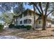 Exterior view of the building with green trees and bushes in front at 491 Ocean Creek Dr. # 2613, Myrtle Beach, SC 29572