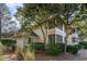 Exterior view of the building surrounded by green landscaping and trees at 491 Ocean Creek Dr. # 2613, Myrtle Beach, SC 29572