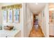Hallway features wood floors, closet space, and coastal decor leading to other rooms at 491 Ocean Creek Dr. # 2613, Myrtle Beach, SC 29572