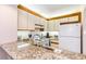 Modern kitchen featuring granite countertops, white appliances, and ample cabinet space at 491 Ocean Creek Dr. # 2613, Myrtle Beach, SC 29572