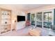 Bright living room with sliding doors to a screened porch and comfortable furnishings at 491 Ocean Creek Dr. # 2613, Myrtle Beach, SC 29572