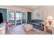 Cozy living room with a sliding door to a screened porch overlooking the outdoor scenery at 491 Ocean Creek Dr. # 2613, Myrtle Beach, SC 29572