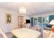 Open-concept living and dining area with screened porch access, adjacent to other living spaces at 491 Ocean Creek Dr. # 2613, Myrtle Beach, SC 29572