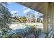 Scenic view overlooking tennis courts and swimming pool from a screened-in porch at 491 Ocean Creek Dr. # 2613, Myrtle Beach, SC 29572