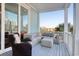 Relax on this spacious balcony with a wicker chair, plush sectional, and stunning outdoor views at 4934 Salt Creek Ct., North Myrtle Beach, SC 29582