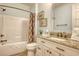 Cozy bathroom with granite countertops, decorative mirror, and a tub/shower combo at 4934 Salt Creek Ct., North Myrtle Beach, SC 29582