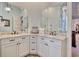 Elegant bathroom featuring double sinks, granite counters, framed mirrors, and white cabinets at 4934 Salt Creek Ct., North Myrtle Beach, SC 29582