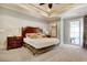 Spacious bedroom featuring a wood headboard, a tray ceiling, and a sliding glass door at 4934 Salt Creek Ct., North Myrtle Beach, SC 29582