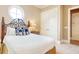 Relaxing bedroom featuring a decorative iron headboard, a round window, and ample closet space at 4934 Salt Creek Ct., North Myrtle Beach, SC 29582