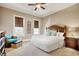 Comfortable bedroom featuring a wooden headboard, two windows, and an accent chair at 4934 Salt Creek Ct., North Myrtle Beach, SC 29582