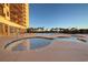 Inviting hot tub and pool with a shallow lounging area, with views of palms at 4934 Salt Creek Ct., North Myrtle Beach, SC 29582
