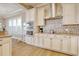 Well-appointed kitchen featuring stainless steel appliances, custom cabinets, and a mosaic tile backsplash at 4934 Salt Creek Ct., North Myrtle Beach, SC 29582