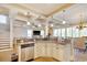 Open kitchen with stainless steel appliances, granite counter tops, and coffered ceiling detail at 4934 Salt Creek Ct., North Myrtle Beach, SC 29582