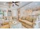 Living room with ceiling fan, comfortable seating, and access to kitchen area at 4934 Salt Creek Ct., North Myrtle Beach, SC 29582
