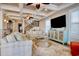 Bright living room with coffered ceilings, staircase, and a large screen tv at 4934 Salt Creek Ct., North Myrtle Beach, SC 29582