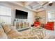 Cozy living room features tray ceilings, a large screen tv, and comfortable seating area at 4934 Salt Creek Ct., North Myrtle Beach, SC 29582