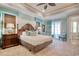 Spacious main bedroom with a king bed, balcony, and a view into the main bath with tiled shower at 4934 Salt Creek Ct., North Myrtle Beach, SC 29582