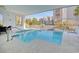Community pool with patio seating and views of surrounding buildings at 4934 Salt Creek Ct., North Myrtle Beach, SC 29582