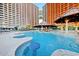 Luxury resort pool featuring a swim up bar, lounge seating, and oceanfront views at 4934 Salt Creek Ct., North Myrtle Beach, SC 29582