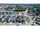 Wide aerial view of a residential community with mature trees and a pond nearby at 5077 Capulet Circle, Myrtle Beach, SC 29588