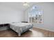 Bright bedroom featuring large window, vaulted ceiling, and hardwood floors at 5077 Capulet Circle, Myrtle Beach, SC 29588