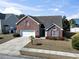 Charming two-story brick home with an attached two-car garage and mature landscaping at 5077 Capulet Circle, Myrtle Beach, SC 29588