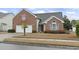 Charming brick home with attached two-car garage, well-kept lawn, and lush landscaping at 5077 Capulet Circle, Myrtle Beach, SC 29588