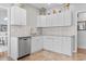 Bright kitchen featuring white cabinetry, granite counters, and stainless steel dishwasher at 5077 Capulet Circle, Myrtle Beach, SC 29588