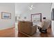 Bright living room with vaulted ceiling, wood floors, and neutral-colored furniture at 5077 Capulet Circle, Myrtle Beach, SC 29588